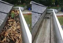 Commercial gutter cleaning clearing valleys, roof gullies and downpipes on office building in Salford Quays